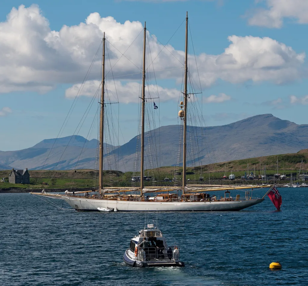 The three-masted schooner Adix at anchor in Oban Bay, with mountains behind