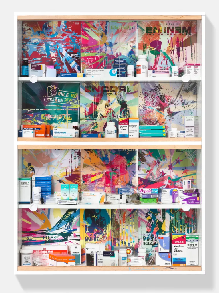 Damien Hirst and Eminem's medicine cabinet Addict: four shelves of Eminem album covers reworked as colourful spin paintings, lined with medicine boxes, bottles and pills