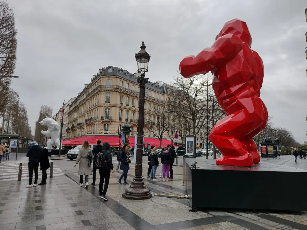 A Wild Kong sculpture on the Champs-Élysées in Paris, with a white Orlinski bear in the distance